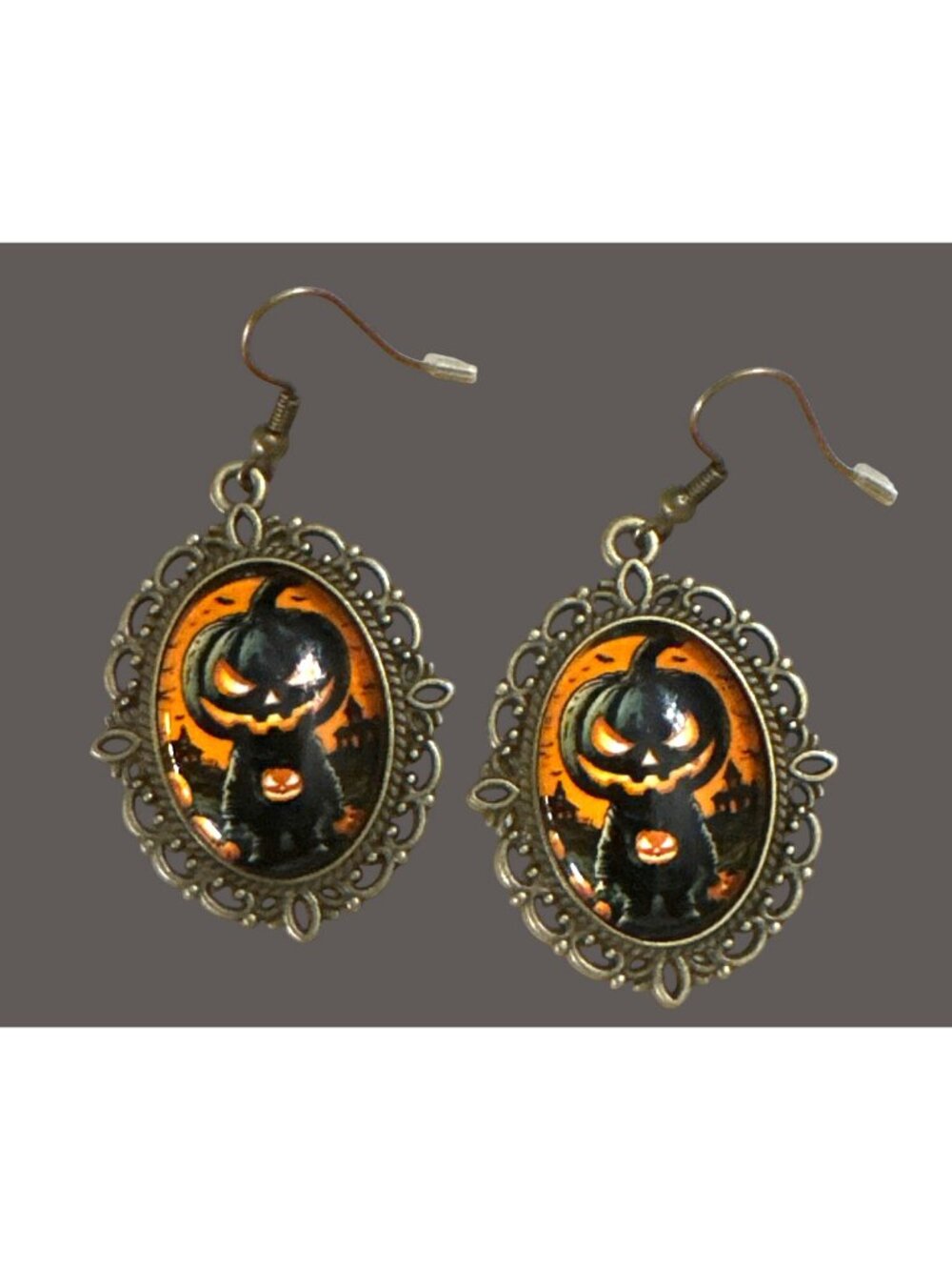 Halloween dangling earrings feature a spooky-cute pumpkin-headed character set i